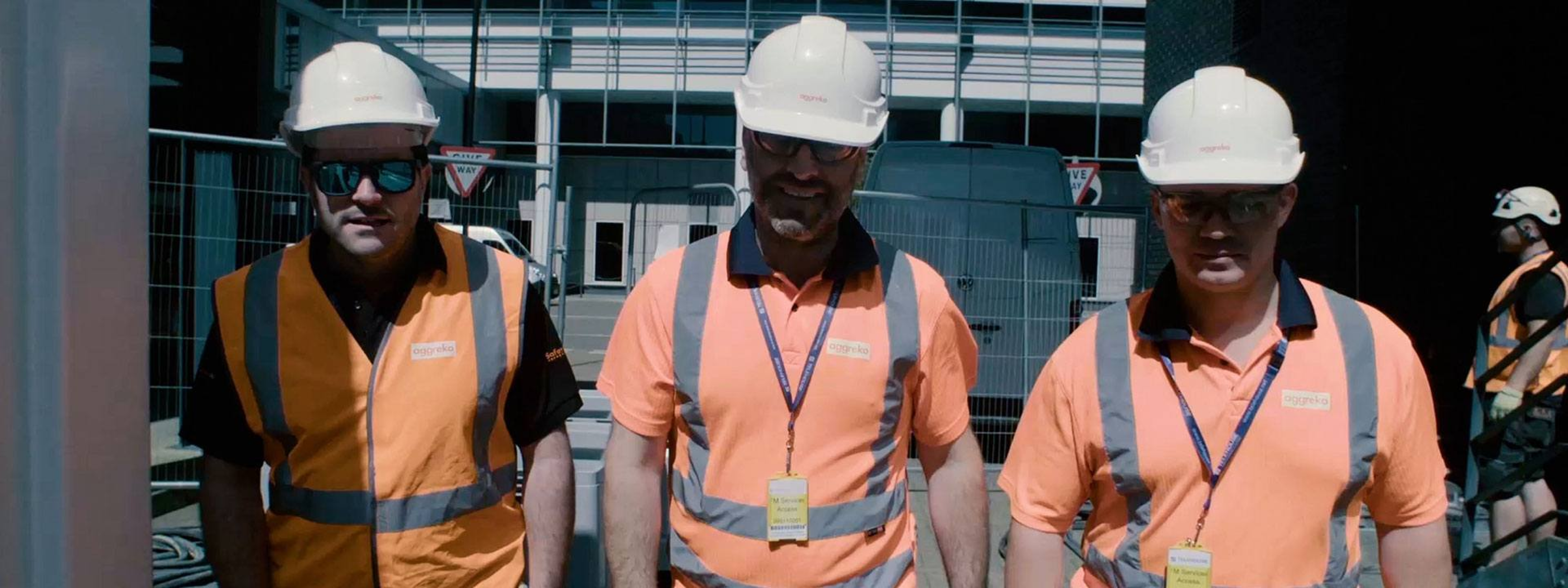 Construction team on active job site in safety gear