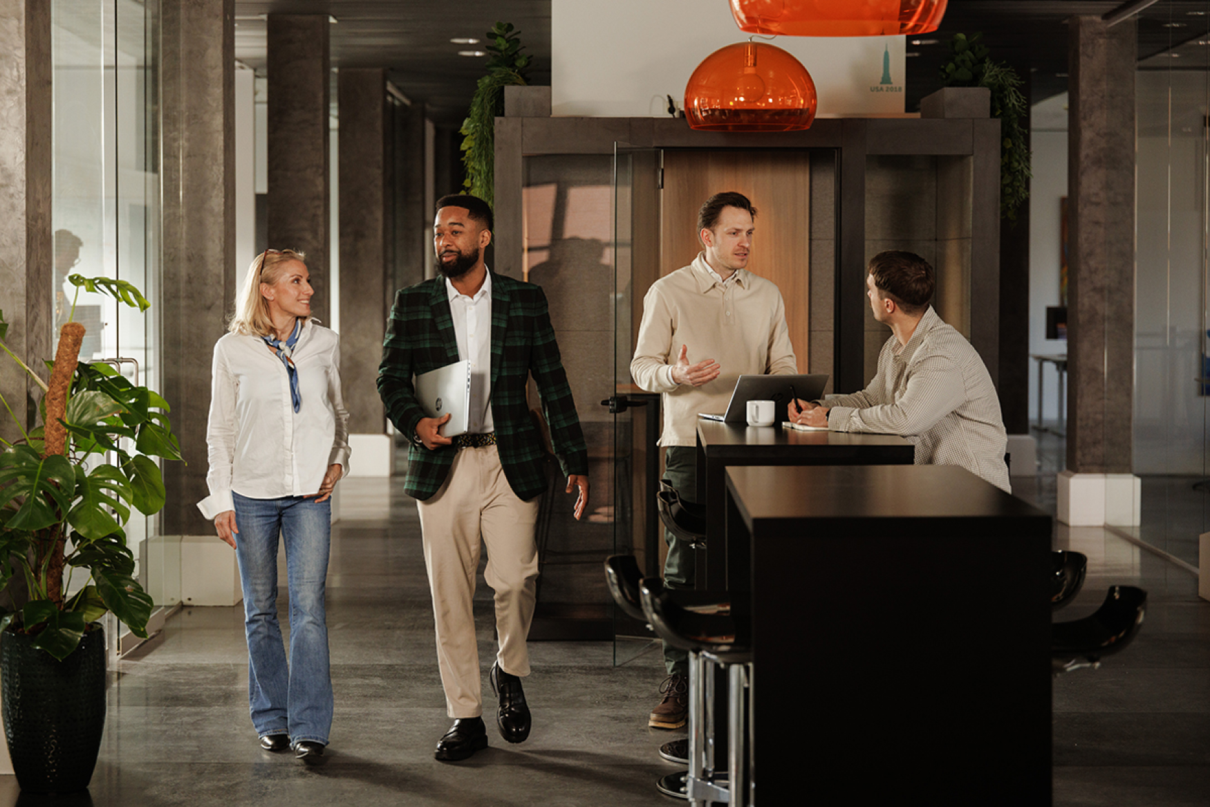 Employees working and walking around their office in dialogue with each other