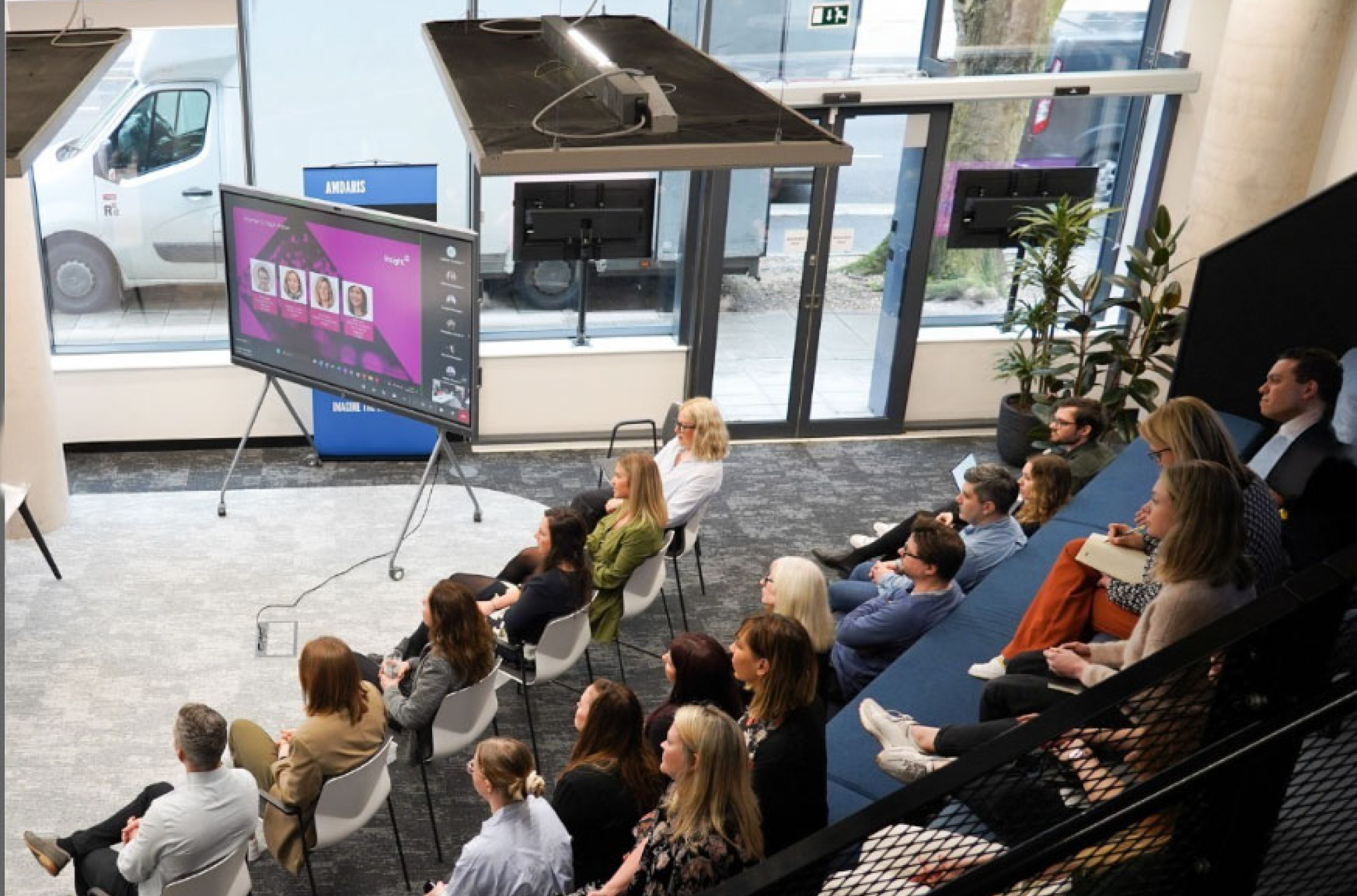 Team attending a presentation in a modern office environment