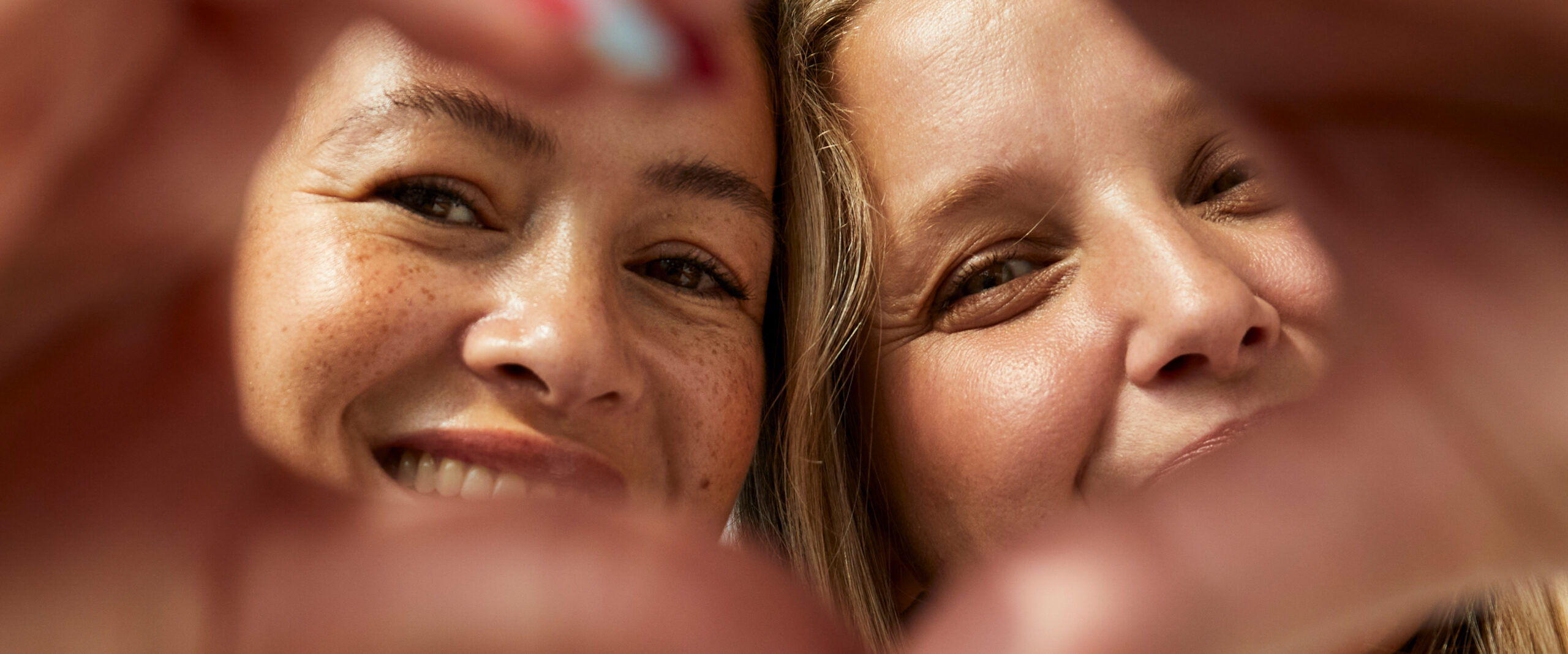 Women shaping a heart with their hands 
