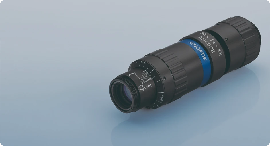 Jenoptik BEX 1X–4X zoom lens on blue background